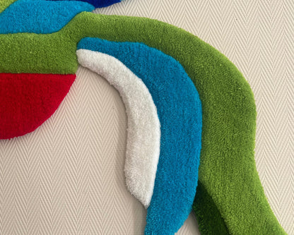 Détail du tufting : relief et texture de la laine acrylique sur le tapis Quetzal.